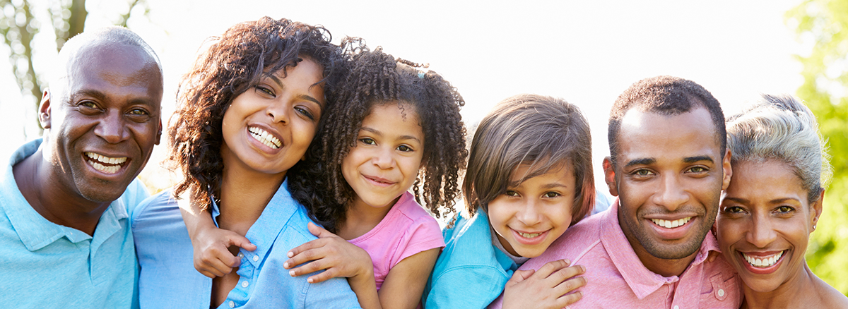 A smiling multigenerational family outdoors